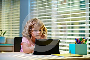 Back to school. Smart school kid boy making homework during quarantine time from corona pandemic disease. Child learning