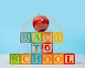 Back to School spelled out in wooden blocks with apple