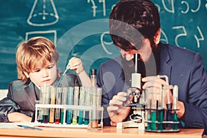 Back to school. student doing science experiments with microscope in lab. father and son at school. teacher man with