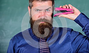 Back to school and studying. Teaching memorization techniques. Teacher bearded man with pink stapler chalkboard photo
