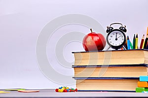 Back to school supplies. Books and red apple