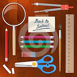 Back to school supplies tools on wood background