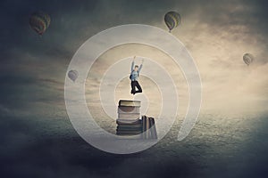 Back to school surreal scene with an overjoyed student boy jumping from the top of a books pile as starts a new adventure.