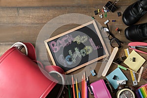 Back to school text on black chalk board with bag