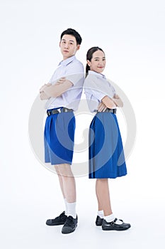 Back to school. Thai students. Asian girl and boy standing together friendly in students uniform on white background