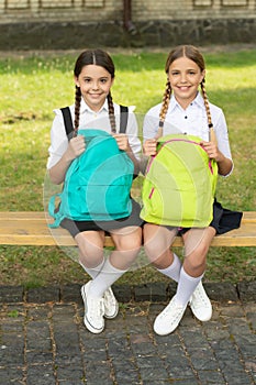 back to school. two happy teen children after school with backpack. friendship of school girls