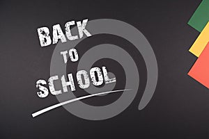 Back to School written on Blackboard, colorful papers on the side simple colorful design