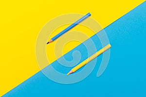 Back to scool - Pencils detail. Colored sharp pencils detail in a row, isolated on blue and yellow