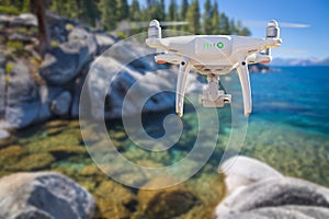 Back of Unmanned Aircraft System UAV Quadcopter Drone Flying At a Lake