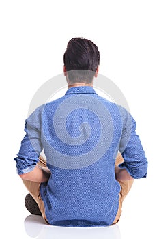 Back veiw of a seated young brunette man