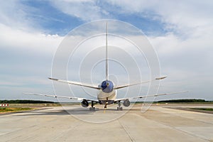 Back view of airplane standing on runway photo