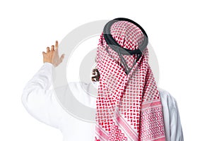 Back view of an Arab man in thobe standing on white isolated background