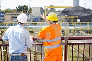 Back view of architects inspecting construction site