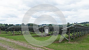 Back view of arrays of solar panels installed on a farm in East Devon, UK