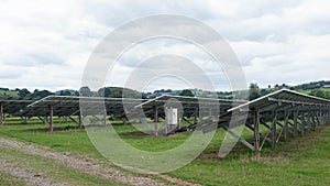 Back view of arrays of solar panels installed on a farm in East Devon, UK photo