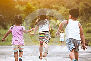 Back view of asian children having fun to run and play together