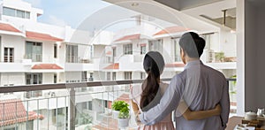 Back view of Asian family standing in front house, AI Generated