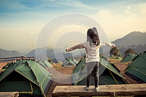 Back view of asian girl expand her arms in camping