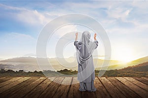 Back view of asian muslim girl with hijab praying