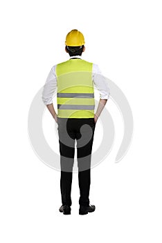 Back view of asian worker wearing safety vest and yellow helmet photo