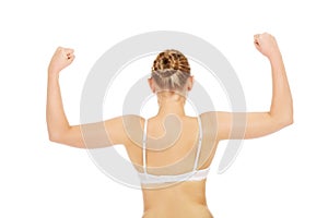Back view of athletic woman show her muscles