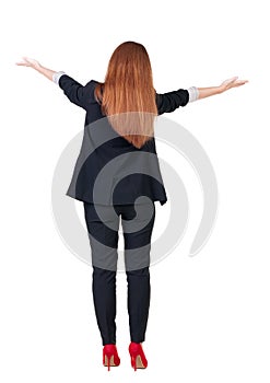 Back view of beautiful business woman welcomes.