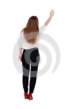 Back view of beautiful business woman welcomes. photo