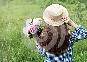 Back view beautiful girl with peonies