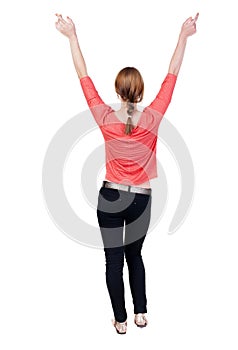 Back view of Beautiful woman in jeans looking at wall and Holds