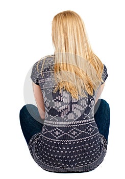 Back view of beautiful woman relaxes and looks into the distance