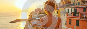 Back view of beautiful young woman admiring scenery while visiting small southern European town on sunny summer day. Banner with