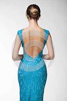 Back view, Beautiful young woman in turquoise tight clothes