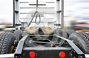 Back view of big rig semi truck tractor with fifth wheel and chassis