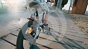 Back view of a boy learning to ride a bike