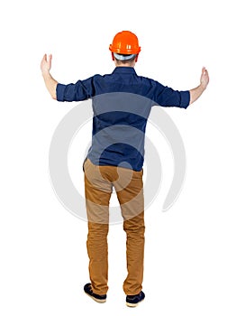 Back view of builder in helmet shows thumbs up