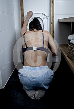 Back view of bulimic woman feeling sick vomiting and throwing up in WC toilet