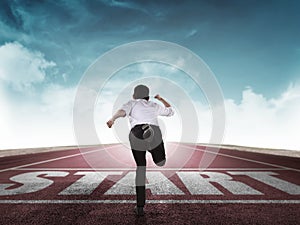 Back view of business man running from start line