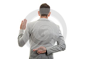 Back view of business man showing fake oath gesture