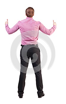 Back view of business man shows thumbs up.