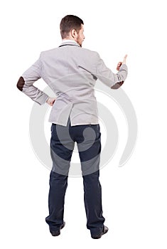 Back view of business man shows thumbs up.