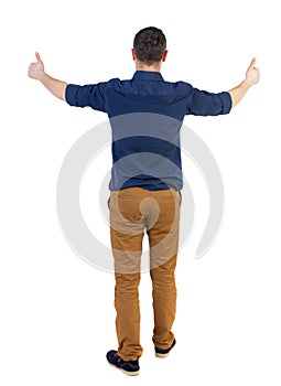 Back view of business man shows thumbs up