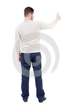 Back view of business man shows thumbs up