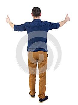 Back view of business man shows thumbs up