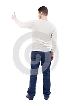 Back view of business man shows thumbs up