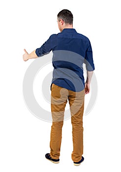 Back view of business man shows thumbs up