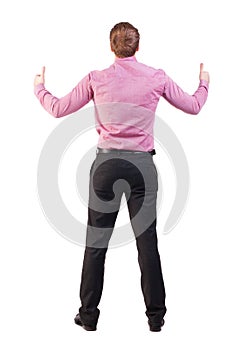 Back view of business man shows thumbs up.