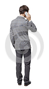 Back view of business man in suit  talking on mobile phone