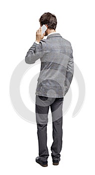 Back view of business man in suit  talking on mobile phone