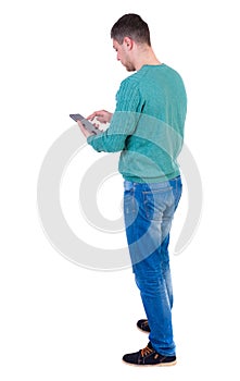 back view of business man uses mobile phone.