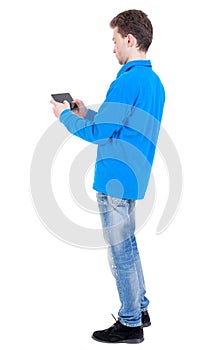 back view of business man uses mobile phone.